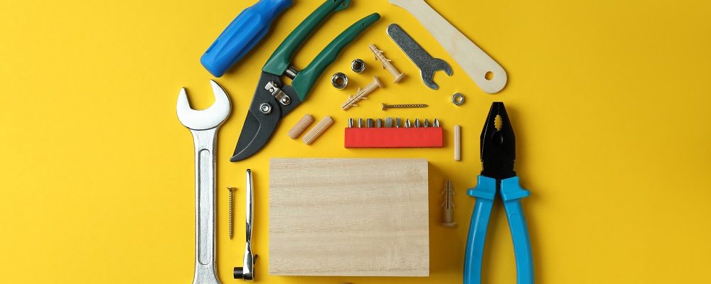 House made of working tools on yellow background